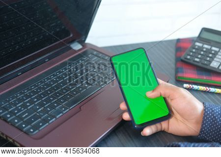Top View Of Man Hand Using Smart Phone On Office Desk