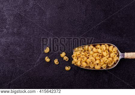 Traditional Dry Pasta On A Black Background. Design Concept. A Copy Of The Space. Selective Focus.