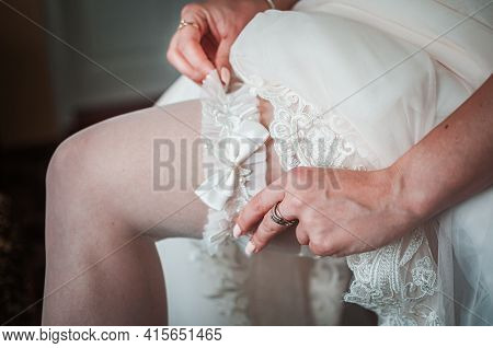Bride Wearing Wedding Garter On The Leg