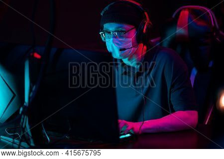 Portrait In A Medical Mask During The International Esports Games Tournament. A Computer Geek With G