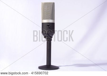Professional Condenser Microphone On A Pedestal Isolated With White Background, Selective Focus.