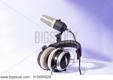 Professional Condenser Microphone And Headphones On White Background, High Key Portrait, Selective F
