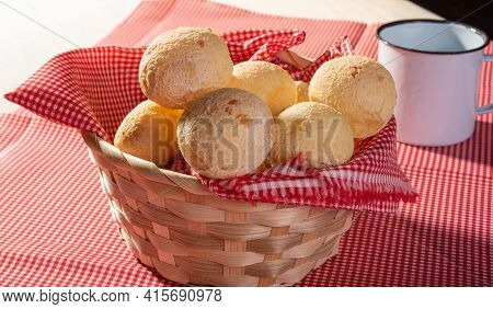 Cheese Bread, Basket Lined With Red And White Fabric Filled With Cheese Bread On A Checkered Towel A