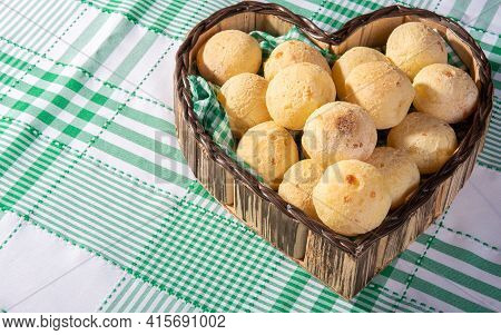 Cheese Bread, Heart-shaped Basket Lined With Green And White Fabric Filled With Cheese Bread On A Ch