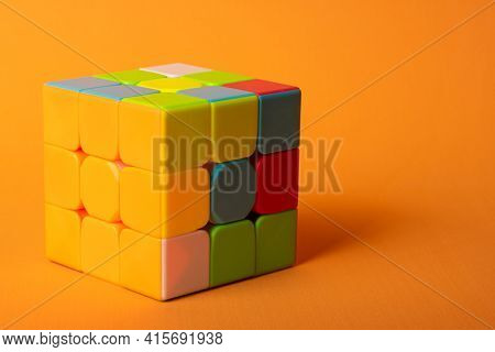 Araras, São Paulo, Brazil, April 4, 2021, A Magic Cube With A Correct Face On An Orange Background A