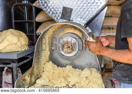 Man Dressed In Black Holding A Freshly Rolled Dumpling At The Mill