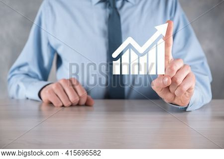 Businessman Man Holding A Graph With Positive Profits Growth. Plan Graph Growth And Increase Of Char