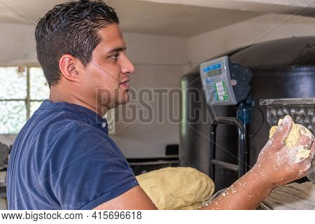 Man Sweating From The Heat Holding Some Fresh Dough