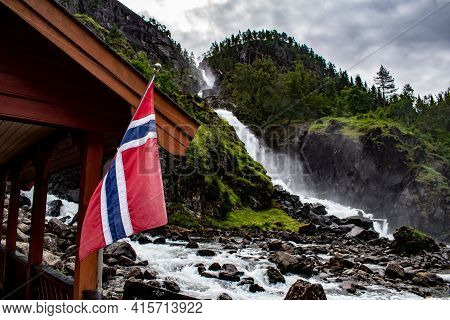 Latefossen Latefoss - One Of The Biggest Waterfalls In Norway, With National Flag On Closeby Buildin