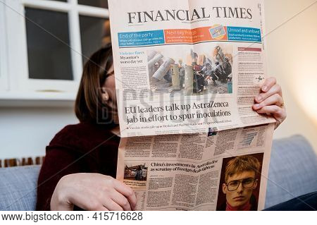 Paris, France - Mar 3, 2021: Woman Reading In Living Room Next To Her Cat The Latest Financial Times