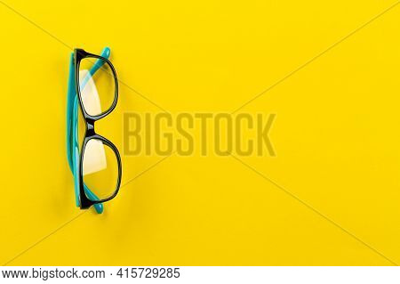 Eyeglasses On Yellow Background, Myopia Or Presbyopia. Eyesight Correction. Fashion Accessories. Spa
