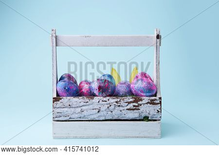 Colorful Painted Eggs With Bright Shiny Gliter In Wooden Basket