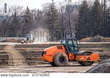 Soil Skating Rink Works To Seal Ground The Base Of Road. Construction Heavy Industrial Machines Buil