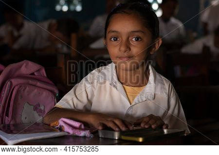 Bluff, Nicaragua. 03-17-2019. Portrait Girl Looking At The Camera Studying At School In The Town Of 