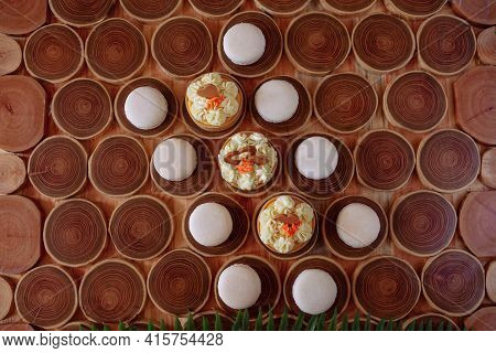 White Delicate Lowly Macaroons On A Wooden Background. The Pastel Tone Of The Cream Inside The Frenc