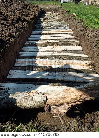 Vertical - Permaculture Trench With Half Long Logs Of Wood