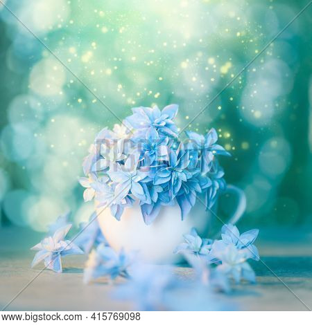 Delicate floral artistic background with blue flowers and bokeh. Conceptual romantic wallpaper design. Fragile blue flowers super macro