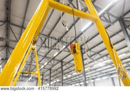 Close Up Red Button. Swivel Electric Crane Hook For Overhead Crane In The Workshop Or Factory