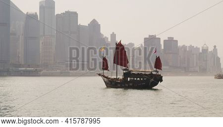 Tsim Sha Tsui, Hong Kong 12 February 2021: hong Kong victoria harbor with red Junk ship
