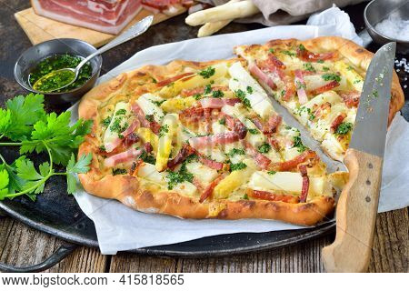 Tarte Flambee From Alsace With Fresh White Asparagus, South Tyrolean Bacon, Parsley With Olive Oil A