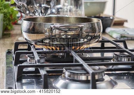 Silver Pan On A Modern Silver Gas Stove In The Kitchen Close-up.