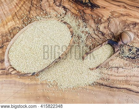 White Amaranth Seed On Brown Olive Wood