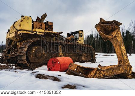 A Big Old Disassembled Faulty Yellow Bulldozer. Broken Crawler Tractor In Disassembled Form With The