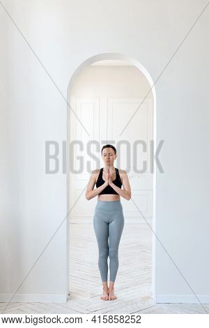 A Young Woman Practices Yoga, Prays And Comprehends Zen In The Arch Of A Bright Room. The Concept Of