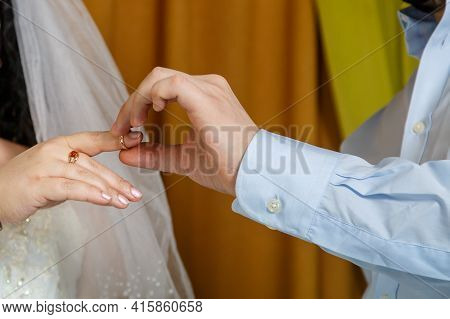The Groom Putting The Bride On The Index Finger At A Jewish Wedding Close-up.