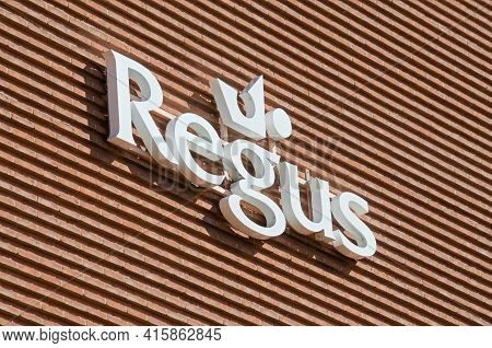 Lugano, Ticino, Switzerland - 16th March 2021 : White Regus Sign Hanging On The Office Building In L