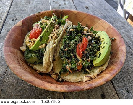 Surf Tacos - Kale Salad With Veggie Mix Tossed In Ginger Tahini Dressing. Served On Warm Pita With G