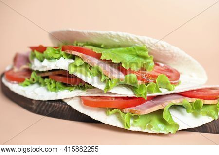 Italian Street Food. Piadina With Ham, Cheese And Tomatoes Close-up View. Piada Made Of Tortillas An