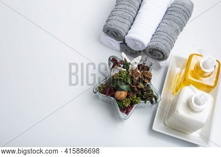 A glass bowl of potpourri. Aromatic dried flowers in the bowl on a bathroom vanity