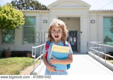 Pupil Of Primary School On The Way To Study. First Grader With School Bag. Beginning Of Lessons. Boy