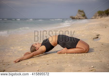 Yoga Practice On The Beach. Caucasian Woman Practicing Paripurna Ustrasana, Full Camel Pose. Kneelin