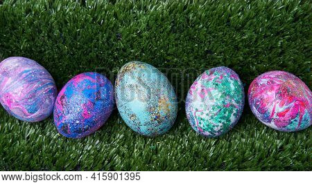 Colorful Eggs With Bright Shiny Gliter On Grass