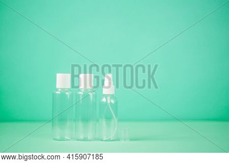 Transparent Plastic Container With A White Lid Of 100 Ml On A Green Background. Travel Jars. Travel 