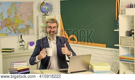 Good Drink For Good Work. Bearded Man With Cup Give Thumb Up. Senior Teacher Drink Coffee In Class. 