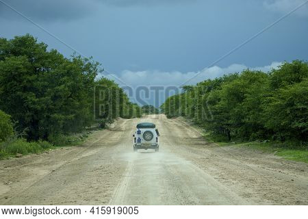 Maun, Botswana, Dec 30: Rear View Of Fully Equiped 4x4 Car Driving On The Wild Dirt Road Towards Mor