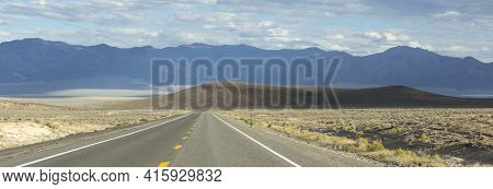 Panorama Of Route 50 - The Loneliest Road In America With Background Of Mountains And Arid Landscape