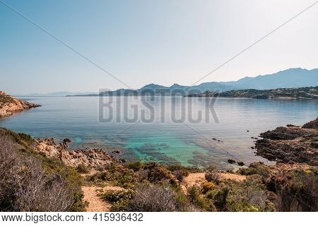 A Small Shallow Cove And Translucent Mediterranean Sea On The Coast Of La Revellata In The Balagne R
