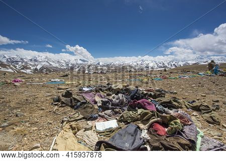 Waste And Old Clothes With The Himalayas Mountain Range In The Background. Friendship Highway Bewtee
