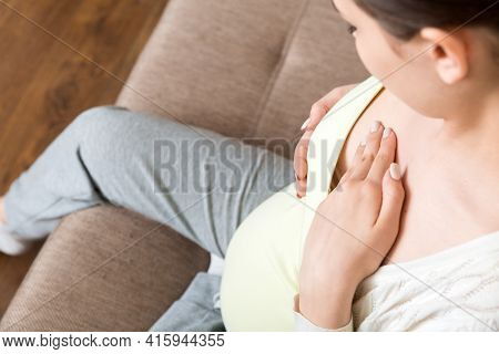 Pregnant Girl Checks Her Breasts. Prevention Of Breast Cancer