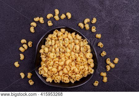 Traditional Dry Pasta On A Black Background. Design Concept. A Copy Of The Space. Selective Focus.
