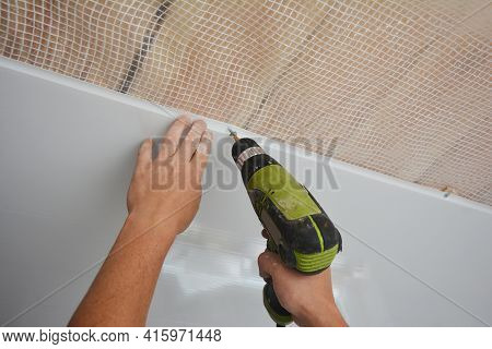 A Builder Is Installing Plastic Ceiling Panel, White Pvc Bathroom Ceiling Cladding In A Bathroom Usi