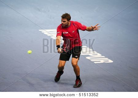 KUALA LUMPUR - SEPTEMBER 26: Stanilas Wawrinka hits a return a match against Marcos Baghdatis at the Malaysia Open 2013 tennis played at the Putra Stadium, Malaysia on September 26, 2013.