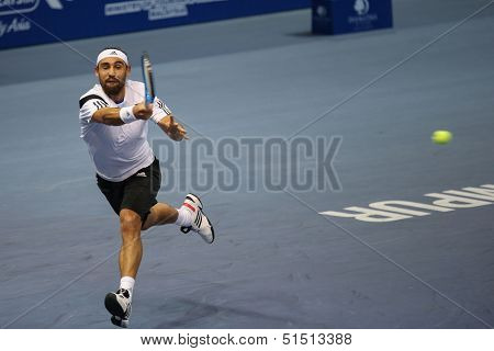 KUALA LUMPUR - SEPTEMBER 26: Marcos Baghdatis hits a return a match against Stanilas Wawrinka at the Malaysia Open 2013 tennis played at the Putra Stadium, Malaysia on September 26, 2013.