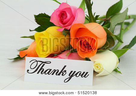 Thank you note and colorful bouquet of roses