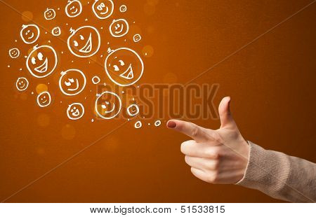 Group of happy hand drawed smiley faces coming out of gun shaped hands