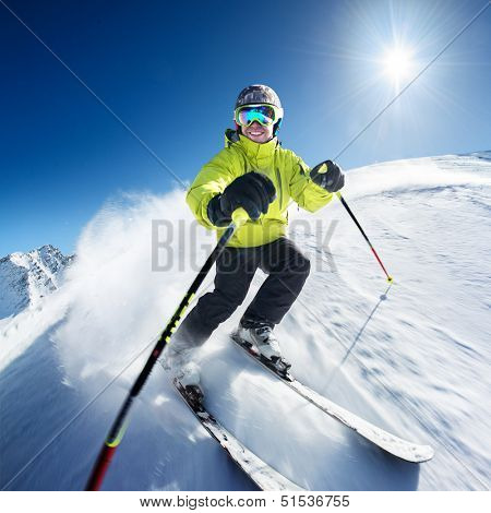 Skier on pise in high mountains